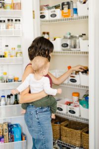 Mom and baby searching in the pantry for dinner ideas